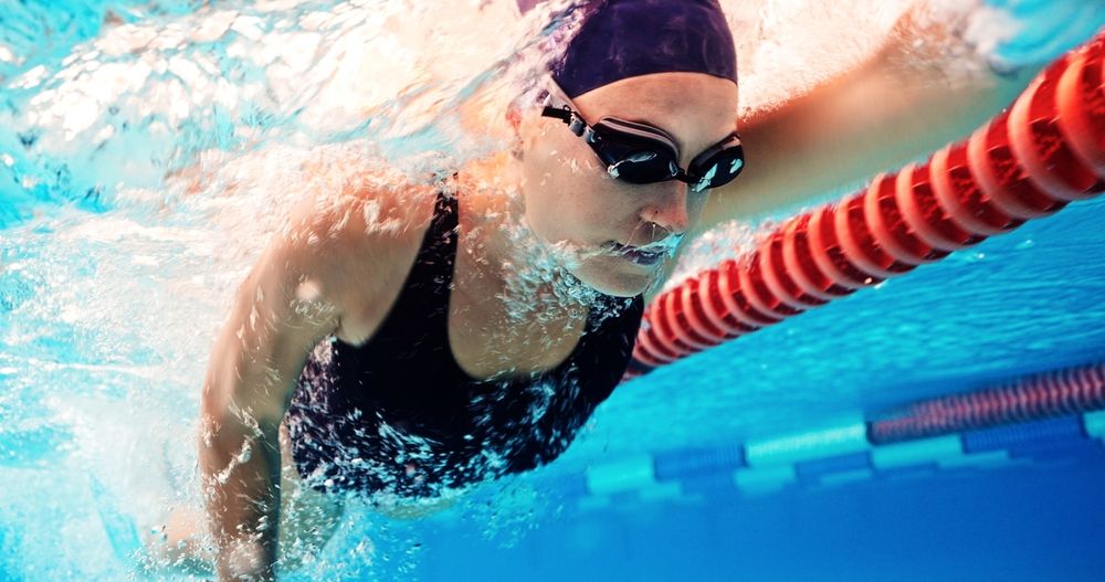 female athlete swimming in pool